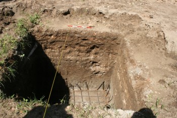 Photograph showing sequence of deposits including an early wall foundation to the right